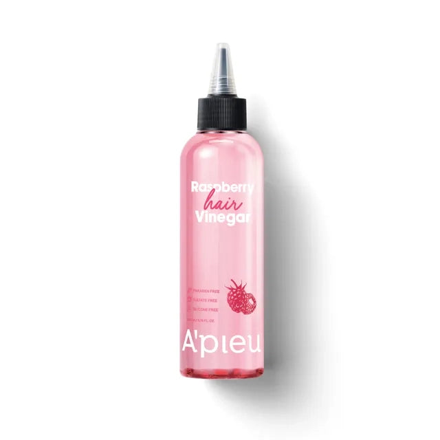 Pink bottle of raspberry hair vinegar with a black cap on a white background